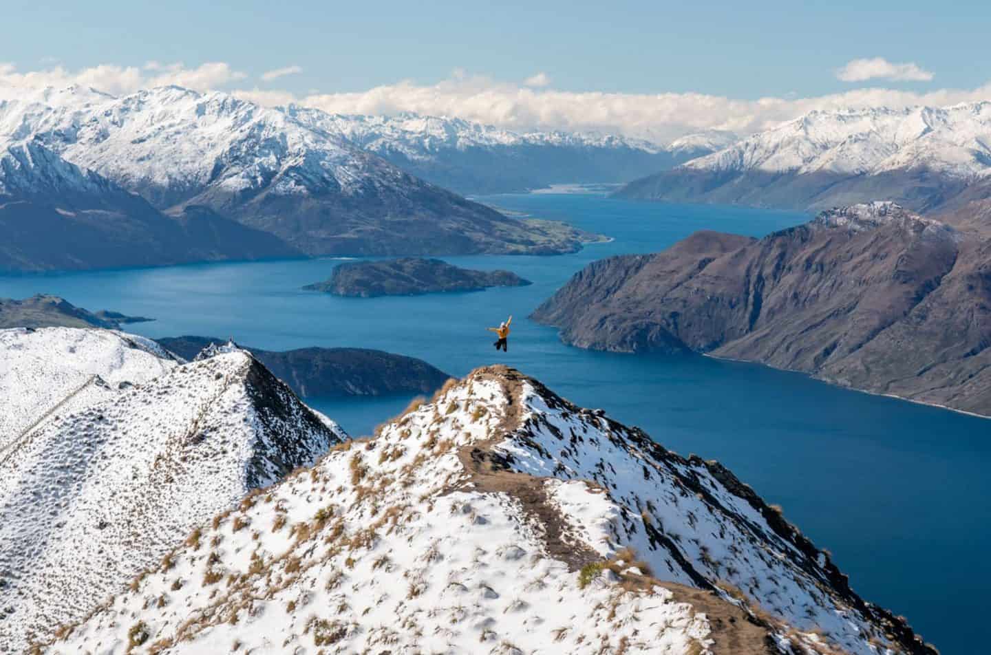Roy's Peak New Zealand landscape with person jumping